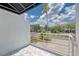The covered tiled balcony features a modern railing and views of a palm tree at 3101 W El Prado Blvd # B, Tampa, FL 33629
