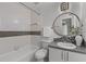 Well-lit bathroom offers stylish tile accents, a round mirror, and a combination shower and tub at 3101 W El Prado Blvd # B, Tampa, FL 33629