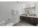 Modern bathroom with double sink vanity, floating cabinets, and large mirror at 3101 W El Prado Blvd # B, Tampa, FL 33629