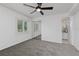 Bright bedroom boasts neutral carpet, a ceiling fan, and a view into an adjacent bathroom through an open doorway at 3101 W El Prado Blvd # B, Tampa, FL 33629