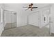 A clean, airy bedroom featuring plush carpeting, a modern ceiling fan, and mirrored closet doors at 3101 W El Prado Blvd # B, Tampa, FL 33629