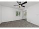 Bedroom featuring a ceiling fan, carpet, and mirrored closet doors at 3101 W El Prado Blvd # B, Tampa, FL 33629