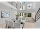 Bright dining room with glass table, white chairs, and view of the private courtyard at 3101 W El Prado Blvd # B, Tampa, FL 33629