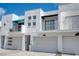 Stylish townhomes with private balconies, garages, and contemporary white facades at 3101 W El Prado Blvd # B, Tampa, FL 33629