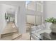 Bright hallway with a glass table, comfortable seating, and courtyard views through sliding glass doors at 3101 W El Prado Blvd # B, Tampa, FL 33629