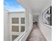Bright hallway featuring modern art, a desk, and large window to the courtyard at 3101 W El Prado Blvd # B, Tampa, FL 33629
