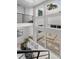 Sunlit interior featuring a glass table, comfortable seating, and courtyard views through sliding glass doors at 3101 W El Prado Blvd # B, Tampa, FL 33629