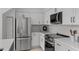 Modern kitchen features stainless steel appliances, white cabinets, and quartz countertops at 3101 W El Prado Blvd # B, Tampa, FL 33629