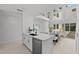 Bright kitchen with white cabinetry and stainless-steel appliances, seamlessly flowing into the dining area at 3101 W El Prado Blvd # B, Tampa, FL 33629