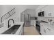 Modern kitchen features stainless steel appliances, white cabinetry, and a sleek black faucet at 3101 W El Prado Blvd # B, Tampa, FL 33629