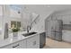 Bright kitchen with white cabinetry, stainless appliances, and a large island with a modern faucet at 3101 W El Prado Blvd # B, Tampa, FL 33629