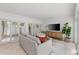 Bright living room with sliding doors, neutral tones, and a stylish entertainment center creates a welcoming atmosphere at 3101 W El Prado Blvd # B, Tampa, FL 33629