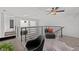 Second-floor loft area with comfortable seating, modern railing, and plenty of natural light at 3101 W El Prado Blvd # B, Tampa, FL 33629