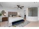 Serene main bedroom with a plush bed, stylish bench, and unique glass block window creating a relaxing retreat at 3101 W El Prado Blvd # B, Tampa, FL 33629