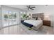 Bright main bedroom features a ceiling fan, sliding doors to the balcony, and an upholstered headboard at 3101 W El Prado Blvd # B, Tampa, FL 33629