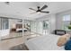 Bright main bedroom features a ceiling fan, mirrored closet doors, and sliding doors to the balcony at 3101 W El Prado Blvd # B, Tampa, FL 33629