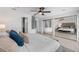 Bright main bedroom features a ceiling fan, mirrored closet doors, and an ensuite bathroom with glass block window at 3101 W El Prado Blvd # B, Tampa, FL 33629