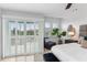 Bright main bedroom features a ceiling fan, sliding doors to the balcony, and a decorative plant at 3101 W El Prado Blvd # B, Tampa, FL 33629