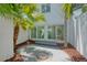 Tropical backyard features an enclosed patio, landscaping and direct access to the home's interior at 3101 W El Prado Blvd # B, Tampa, FL 33629