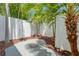 Private, tropical patio area with a unique, decorative stone accent circle set amongst lush greenery at 3101 W El Prado Blvd # B, Tampa, FL 33629