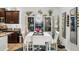 A formal dining room with a white table, chairs, mirrored accents, and a decorative chandelier at 31251 Mango Fade Way, San Antonio, FL 33576