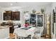 A formal dining room with a white table, chairs, mirrored accents, and a decorative chandelier at 31251 Mango Fade Way, San Antonio, FL 33576