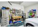 Organized garage featuring storage cabinets, pegboard tool organizer, and a clean epoxy floor at 31251 Mango Fade Way, San Antonio, FL 33576