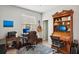 Home office with a large desk, bookshelves, two monitors, and natural light from the window at 31251 Mango Fade Way, San Antonio, FL 33576