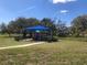 Community playground with shade, picnic benches, and a paved sidewalk at 31251 Mango Fade Way, San Antonio, FL 33576