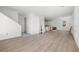 Open-concept living area with hardwood floors, white walls, and a view of the kitchen area at 3207 N Florida Ave # 1, Tampa, FL 33603