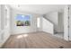 Bright living area featuring light wood floors, a large window, and stairs to the upper level at 3207 N Florida Ave # 1, Tampa, FL 33603