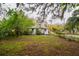 Lush backyard with mature trees creating a private outdoor space at 3425 E Powhatan Ave, Tampa, FL 33610