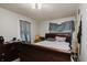 Spacious primary bedroom features a large bed, dresser and lots of natural light at 3425 E Powhatan Ave, Tampa, FL 33610