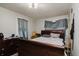 Bedroom features a wooden sleigh bed with dark wood dresser at 3425 E Powhatan Ave, Tampa, FL 33610