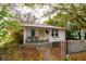 Front exterior of a cute single-story home, featuring a yellow door and small covered porch at 3425 E Powhatan Ave, Tampa, FL 33610