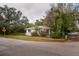 Charming exterior view of home with mature landscaping in a quiet neighborhood at 3425 E Powhatan Ave, Tampa, FL 33610