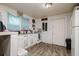 Bright kitchen featuring a window, wood-look floors and white cabinets at 3425 E Powhatan Ave, Tampa, FL 33610
