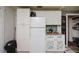 A full view of the kitchen area and cabinets plus full size refrigerator appliance at 3425 E Powhatan Ave, Tampa, FL 33610