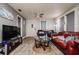 Inviting living room with wood-look floors, fan, and comfortable furnishings at 3425 E Powhatan Ave, Tampa, FL 33610