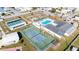 Aerial view of community with swimming pool, tennis courts, and green spaces for activities and relaxation at 35145 Garber Ln, Zephyrhills, FL 33541