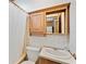 A bathroom featuring a vanity, toilet, tub, and shower with neutral wallpaper at 35145 Garber Ln, Zephyrhills, FL 33541