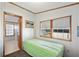 Cozy bedroom with a twin bed, a bright window view, and a neutral color scheme at 35145 Garber Ln, Zephyrhills, FL 33541