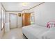 A bedroom with a bed, white walls, and a view into the hallway at 35145 Garber Ln, Zephyrhills, FL 33541