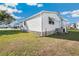Home's exterior offers durable siding, complementing the beautiful surrounding greenery and shade at 35145 Garber Ln, Zephyrhills, FL 33541