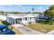 Cozy one-story home showcasing carport and small front porch at 35145 Garber Ln, Zephyrhills, FL 33541