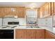 View of kitchen with wood laminate flooring and white laminate countertops at 35145 Garber Ln, Zephyrhills, FL 33541