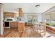 A kitchen and dining area featuring natural wood cabinets, light countertops, and laminate floors at 35145 Garber Ln, Zephyrhills, FL 33541