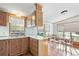 A kitchen with natural wood cabinets, light countertops, and a window above the sink at 35145 Garber Ln, Zephyrhills, FL 33541