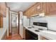 Kitchen area with wood laminate flooring and white appliances at 35145 Garber Ln, Zephyrhills, FL 33541