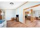 A living room leading to the kitchen and hallway with wood-look laminate floors at 35145 Garber Ln, Zephyrhills, FL 33541